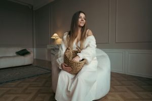 a woman sitting in a chair with a basket