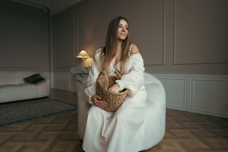 a woman sitting in a chair with a basket